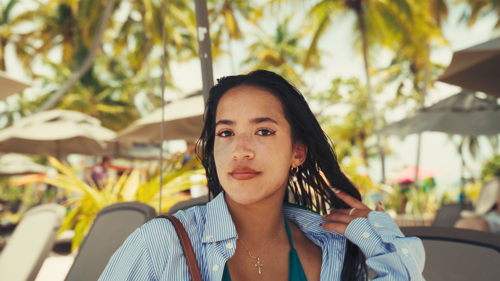 A woman under palm trees at a resort