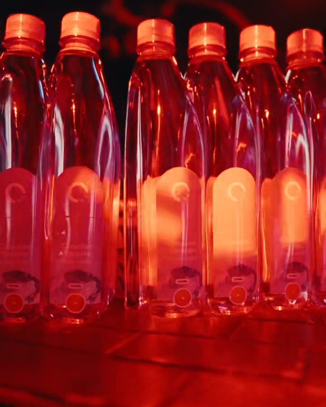 Bottles lit red at the OneWater New Year&rsquo;s party