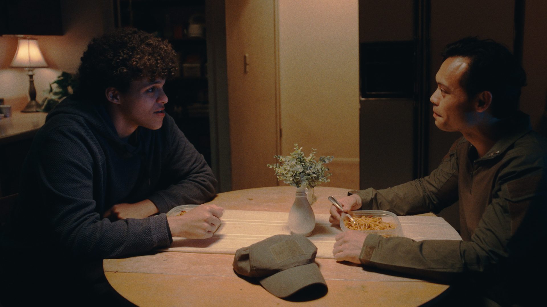 Still from Sundered: two men at a kitchen table